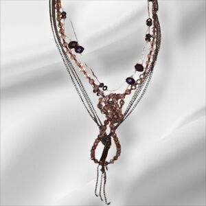 Two purple long beaded necklaces costume jewelry versatile avon mark.